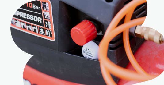 BLE tracking device half hidden in work equipment.