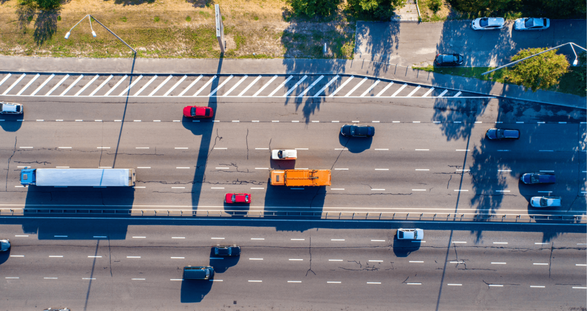 View form above on a busy highway with multiple cars of different make, color and type.