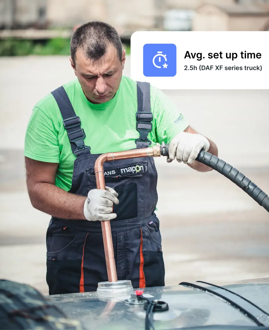 Technician performing fleet fuel management equipment installation to enhance vehicle fuel control.