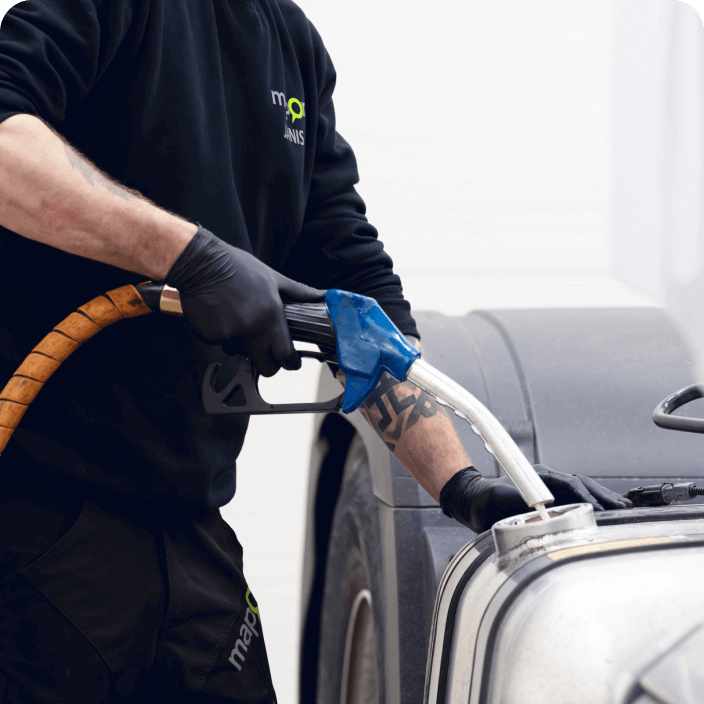 A Mapon technician drains the truck's tank to install a fuel consumption sensor.