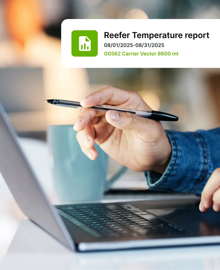 Person reviewing data on a laptop with a “Reefer Temperature report” alert displayed.