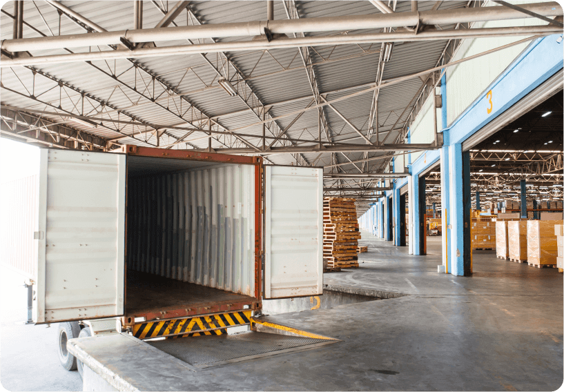 A photo of an open trailer equipped with fleet camera systems for added safety, parked in a garage.