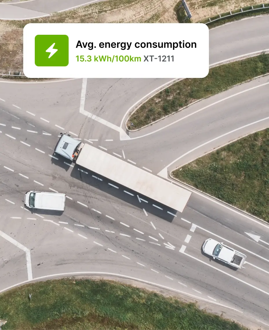 Ilmakuva kuorma-autoista ja pakettiautoista tiellä, ja kuvan päällä on Maponin ilmoitus energiankulutustiedoista sähköajoneuvoille