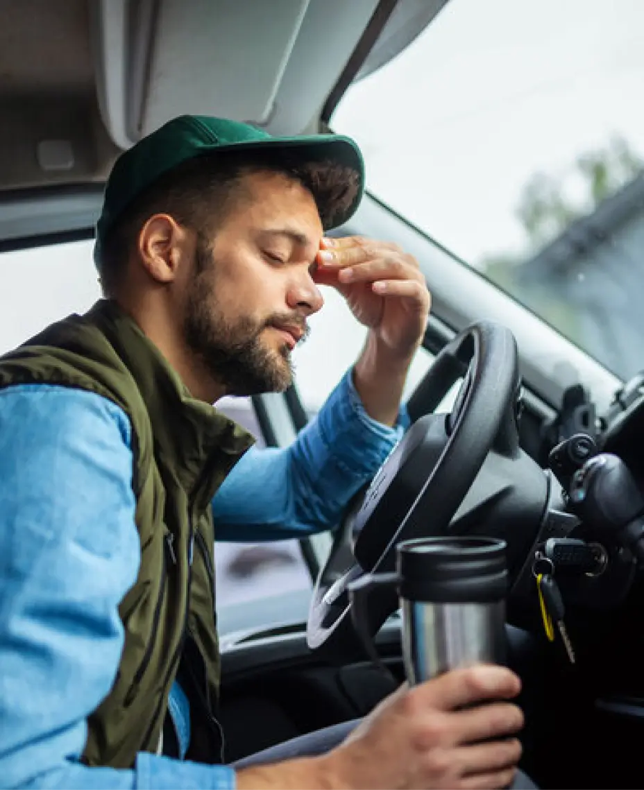 Driver showing signs of fatigue detected by AI-based video telematics inside a commercial vehicle.