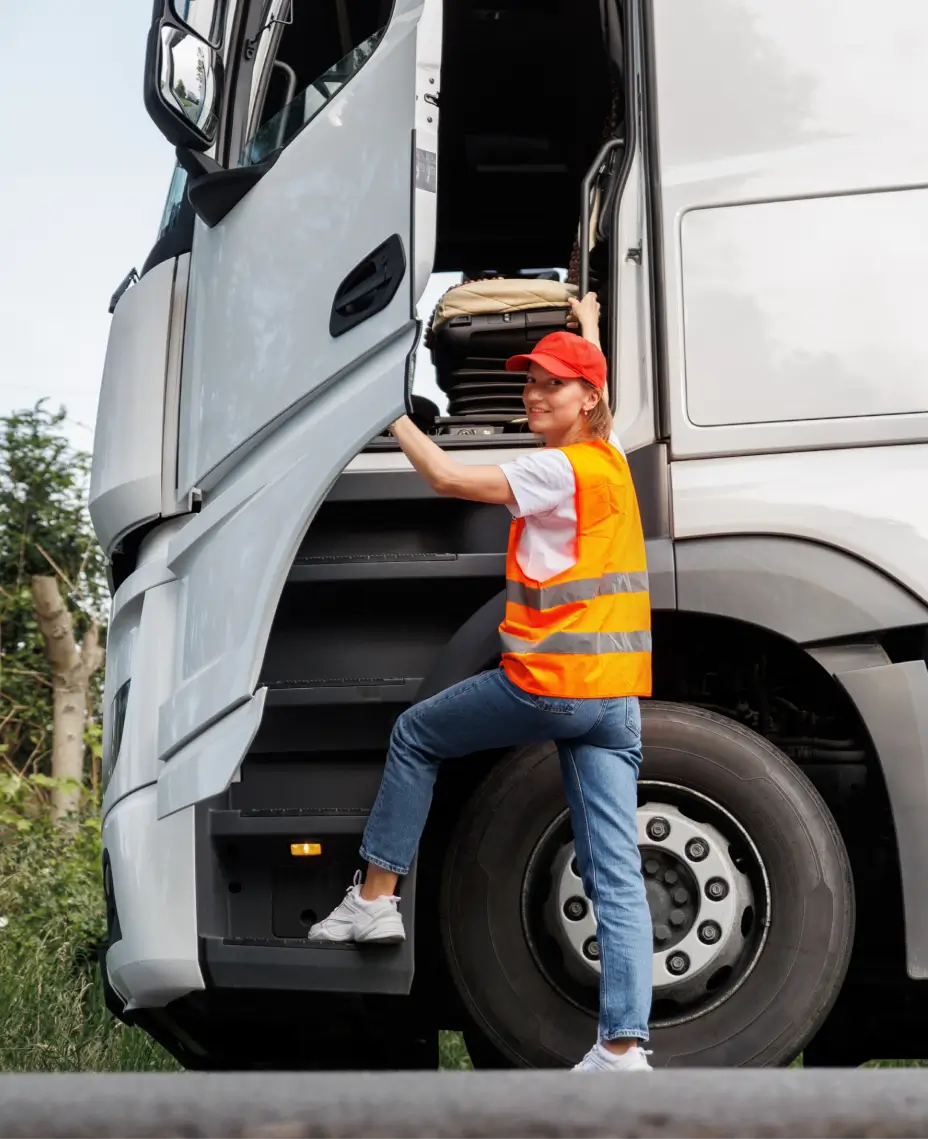 Truck driver entering vehicle cabin equipped with AI video telematics and in-cab safety cameras.